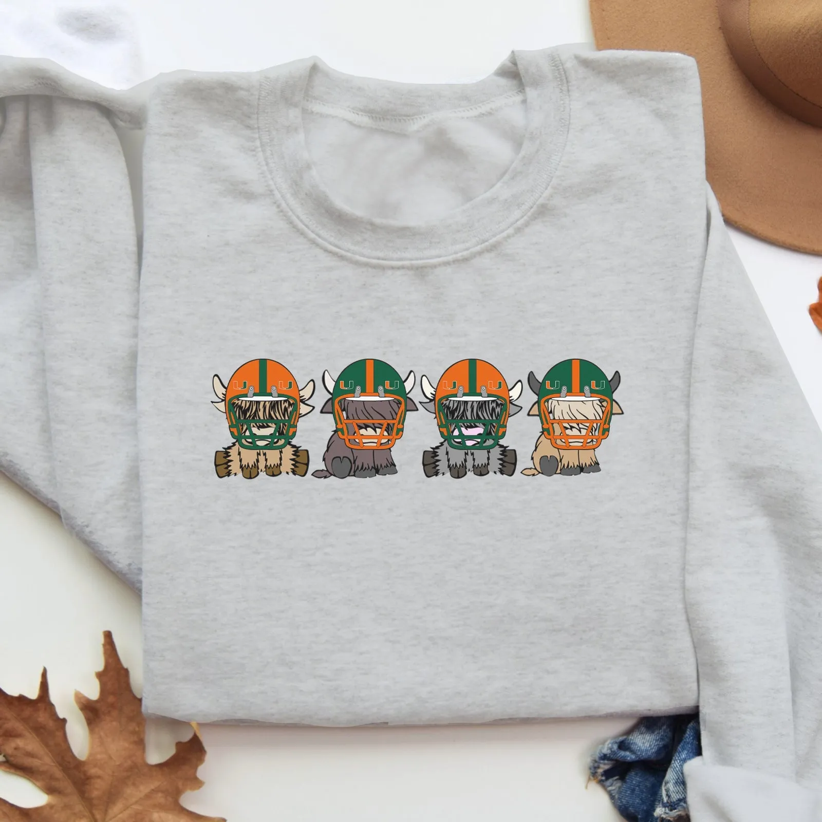 Miami Hurricanes Football Highland Cow Football Team Football Lovers Gift Unisex Crewneck Hoodie Sweatshirt